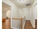 Hallway with wood floors and staircase, showing multiple doorways leading to other rooms at 825 Rock Lake Gln, Fort Mill, SC 29715