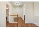 Hallway featuring wood floors and staircase, connecting various rooms in the home at 825 Rock Lake Gln, Fort Mill, SC 29715