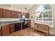 Efficient kitchen features modern appliances, ample counter space, and natural light from a large window at 825 Rock Lake Gln, Fort Mill, SC 29715