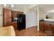 Bright kitchen with wooden cabinets, black refrigerator and view into adjacent spaces at 825 Rock Lake Gln, Fort Mill, SC 29715