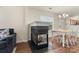 Inviting living space featuring a fireplace, wood flooring, and dining table near a window at 825 Rock Lake Gln, Fort Mill, SC 29715