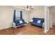 Bright living room with two blue futons with decorative pillows, illuminated by a ceiling fan at 825 Rock Lake Gln, Fort Mill, SC 29715