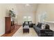 Open living room area featuring a vaulted ceiling, ceiling fan, entertainment center, and comfortable seating at 825 Rock Lake Gln, Fort Mill, SC 29715