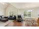 Open-concept living room with fireplace, plush seating, and a dining table at 825 Rock Lake Gln, Fort Mill, SC 29715