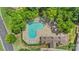 Aerial view of a community pool surrounded by lounge chairs and lush landscaping, perfect for summer relaxation at 825 Rock Lake Gln, Fort Mill, SC 29715