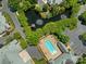 Aerial view of the community pool, clubhouse, pond, gazebo and lush landscaping at 8465 Olde Troon Dr, Charlotte, NC 28277