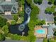 Aerial view of community pool, pond with fountains, and parking area, surrounded by mature trees at 8465 Olde Troon Dr, Charlotte, NC 28277