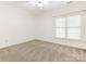 A bright bedroom with a neutral carpet and a window letting in natural light at 8465 Olde Troon Dr, Charlotte, NC 28277