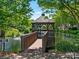 Picturesque gazebo on a pond, surrounded by lush landscaping and mature trees at 8465 Olde Troon Dr, Charlotte, NC 28277