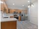 Kitchen with stainless steel appliances, including a refrigerator and modern countertops at 8465 Olde Troon Dr, Charlotte, NC 28277