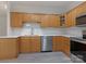 Kitchen with stainless steel appliances, including a dishwasher and sink, and modern countertops at 8465 Olde Troon Dr, Charlotte, NC 28277