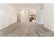 Open-concept living space with hardwood floors and a seamless flow to the kitchen area at 8465 Olde Troon Dr, Charlotte, NC 28277