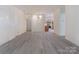 Open floor plan featuring a dining area, living room, and view of the kitchen, and modern floors at 8465 Olde Troon Dr, Charlotte, NC 28277