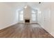 Spacious living room boasting a fireplace, high ceilings, wood floors, and large windows at 8465 Olde Troon Dr, Charlotte, NC 28277