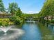 Scenic pond with a fountain feature, enhancing the natural beauty of the community at 8465 Olde Troon Dr, Charlotte, NC 28277