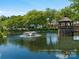 Picturesque pond view featuring a charming gazebo, fountain, and lush greenery at 8465 Olde Troon Dr, Charlotte, NC 28277