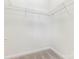 Neutral walk-in closet with carpet and white wire shelving. Ideal for organizing any wardrobe at 8465 Olde Troon Dr, Charlotte, NC 28277