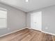 A well-lit bedroom boasts laminate floors and a double door closet, offering both style and practical storage solutions at 9136 Creedmore Hills Dr, Charlotte, NC 28214