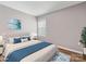 This bedroom features a comfortable bed with soft blue accents and a modern painting, enhancing the cozy ambiance at 9136 Creedmore Hills Dr, Charlotte, NC 28214