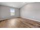 Bright bedroom with wood floors, a vaulted ceiling, and a large window at 9136 Creedmore Hills Dr, Charlotte, NC 28214