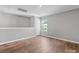 Open bonus room with wood floors, natural light, and neutral paint ready to be customized at 9136 Creedmore Hills Dr, Charlotte, NC 28214
