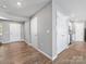 Entryway featuring wood floors, neutral walls, and white doors leading to kitchen and rooms at 9136 Creedmore Hills Dr, Charlotte, NC 28214