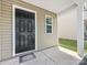 Close up of a six panel black front door with small window and a covered porch at 9136 Creedmore Hills Dr, Charlotte, NC 28214