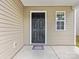 Close up of a six panel black front door with small window and a covered porch at 9136 Creedmore Hills Dr, Charlotte, NC 28214