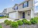 Charming two-story home with a two car garage, black front door, and landscaped yard at 9136 Creedmore Hills Dr, Charlotte, NC 28214