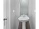 Half bathroom featuring a pedestal sink, new faucet, gray walls, and white trim at 9136 Creedmore Hills Dr, Charlotte, NC 28214