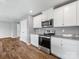 The kitchen showcasing stainless steel oven, microwave, and white cabinets at 9136 Creedmore Hills Dr, Charlotte, NC 28214