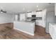 Modern kitchen with large island, granite countertops, and stainless steel appliances at 9136 Creedmore Hills Dr, Charlotte, NC 28214