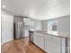 A modern kitchen showcasing an island with stainless steel dishwasher at 9136 Creedmore Hills Dr, Charlotte, NC 28214