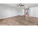 Bright living room featuring hardwood floors, ceiling fan, and neutral paint at 9136 Creedmore Hills Dr, Charlotte, NC 28214