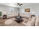 Staged living room featuring neutral furniture, rug, ceiling fan, and neutral walls at 9136 Creedmore Hills Dr, Charlotte, NC 28214