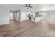 Open concept living room showcasing hardwood floors and view of the kitchen area at 9136 Creedmore Hills Dr, Charlotte, NC 28214