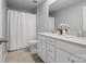 Bathroom with dual sink vanity, tiled floor and shower with white shower curtain at 1008 Whipcord Dr, Waxhaw, NC 28173