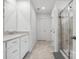 Bright bathroom featuring a walk-in shower and white cabinets at 1008 Whipcord Dr, Waxhaw, NC 28173