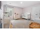 Bedroom with playful design featuring soft pink walls, plush carpet, a toddler bed and dresser at 1008 Whipcord Dr, Waxhaw, NC 28173