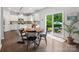 Open concept dining area connecting to kitchen with wood table and chairs, bright patio at 1008 Whipcord Dr, Waxhaw, NC 28173
