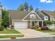 Well-maintained exterior of the home with attached garage, landscaped yard and inviting curb appeal at 1008 Whipcord Dr, Waxhaw, NC 28173