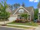 Beautiful exterior showcasing manicured lawn and vibrant flower beds, adding to the curb appeal at 1008 Whipcord Dr, Waxhaw, NC 28173