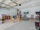 Garage featuring epoxy floors and a wall-mounted television at 1008 Whipcord Dr, Waxhaw, NC 28173