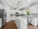Well-lit kitchen with stainless steel appliances, white cabinets and countertops, and pendant lighting at 1008 Whipcord Dr, Waxhaw, NC 28173