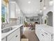 Bright, open kitchen flows into the living area, featuring stainless appliances, white cabinets and a view to the backyard at 1008 Whipcord Dr, Waxhaw, NC 28173