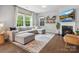 Cozy living room boasts a fireplace, large windows, and stylish decor at 1008 Whipcord Dr, Waxhaw, NC 28173