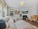 Light-filled living room with fireplace, hardwood floors, and comfortable sectional at 1008 Whipcord Dr, Waxhaw, NC 28173