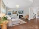 Bright living room featuring a fireplace, comfortable seating, and hardwood floors at 1008 Whipcord Dr, Waxhaw, NC 28173