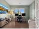 Modern office with TV, wainscoting, hardwood flooring and abundant natural light at 1008 Whipcord Dr, Waxhaw, NC 28173