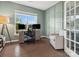 Stylish office space with hardwood flooring, wainscoting, and a large window at 1008 Whipcord Dr, Waxhaw, NC 28173